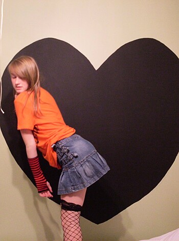 "Chick grindin on the fuckin black heart-shaped hole in the wall, wearin her tight jean skirt an that snazzy orange tee."