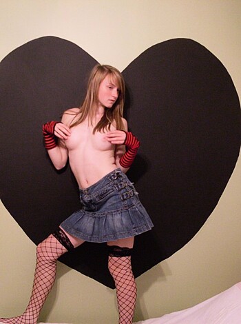 Vulgar description:
"""
Here's an f**king photo of some hot chick in tight ass fishnets, showing off her smooth legs and fingering her p***y like a pro.
"""