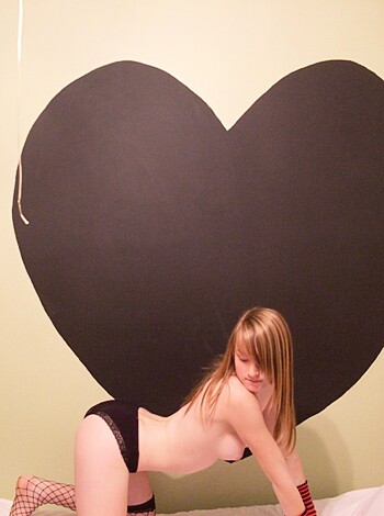 "Here's a slutty bitch posin' with her tits out and shit, fuckin' the camera from a heart-shaped prop."