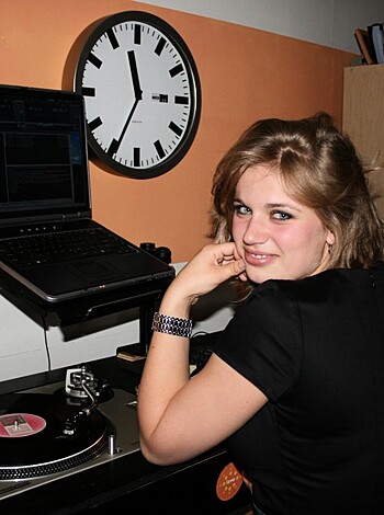 "Check out this image of some hot babe with big tits, legs spread wide open, sitting in front of her computer, playing with her pussy while typing away on the keys. She's got a fucking sexy smile on her face, and she looks so goddamn seductive surrounded by all that high-tech equipment."