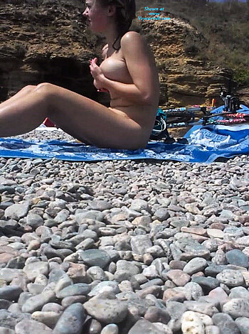 Here's a fuckin' vulgar description of this picture: It's a damn nude snap of a hoe posing for the cameras on the sandy shore, flaunting her tits and pussy like some kinda slut.