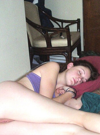 A nude broad is spread-eagle on her mattress.