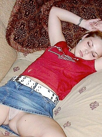 "Here's the caption, you f*ckin' bitch! Lying down on a couch with your fat ass spread out wide, showing off that shiny red top and those nasty fuckin' denim shorts! You look like a f*cked up ho, taking a nap while some dickhead rubs one out in the background."