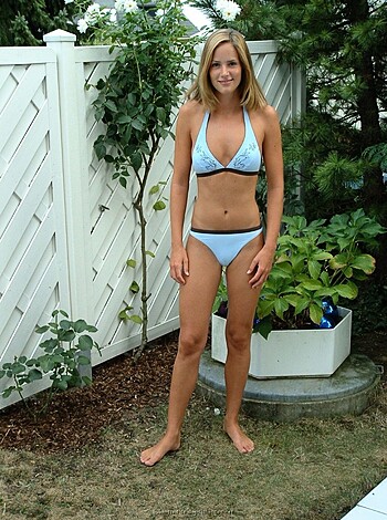 A fucking hot babe in a sexy ass bikini sunbathing on the beach.