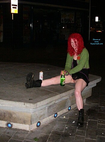 "A fat fucking couple sits on some wooden bench."
