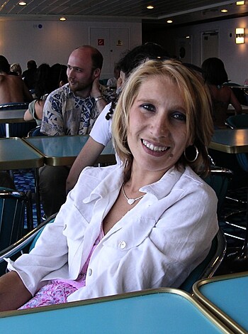 Here's the vulgar caption for this image: "Smilein', boob-staring hottie sittin' on a stool."