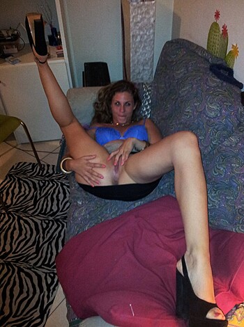 "Fucking hot babe in tight ass thong showing off her pussy while chilling on the sofa."