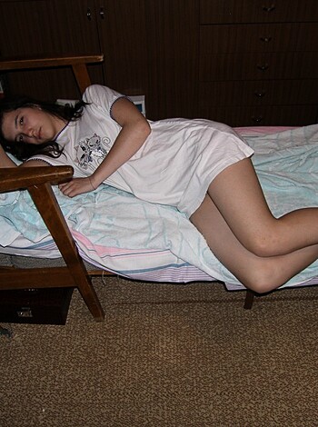 A bare ass chick laid out on some sheets.