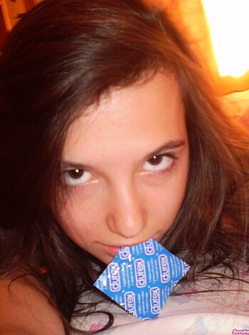 A chick is sucking on a Durex wrapper like it's some kinda lollipop, yo!