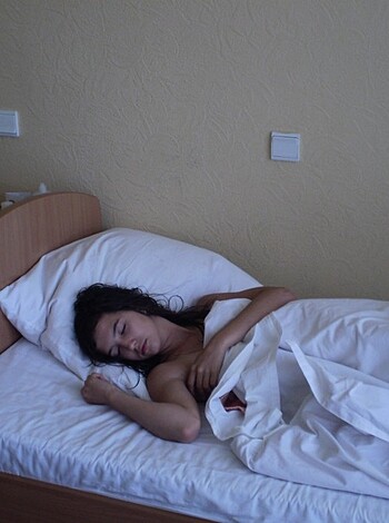 The b***h is passed out and naked as f**k in her s***ty ass bed.