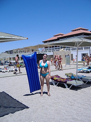 "Holding up her blow-up doughnut, this sunbathing babe is ready to sink her cock into the ocean."