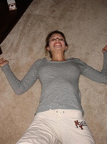 Vulgar description: "Check out this hot babe in a tank top and shorts, showing off her tight ass and big tits while stretching out like a fucking yoga master."