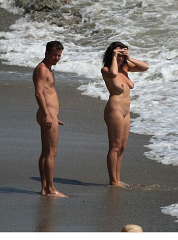 """
Two fucking nude adults posing by the ocean shore.
""
