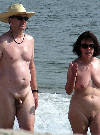 """
Hairy dude and hot chick getting frisky on the sand, sans clothes.
""