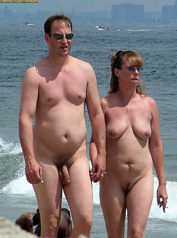 "Here are two fully nude humans strolling down the shore, exposing their genitalia and nipples for all to see."