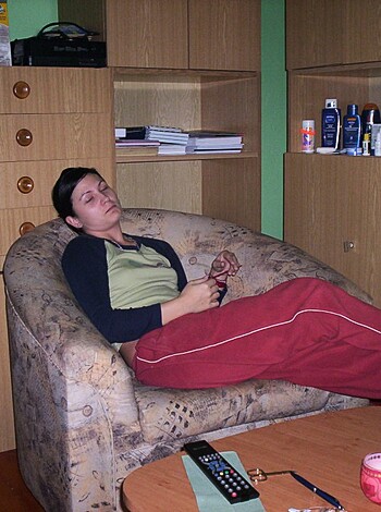 The chick is sitting by herself on a fucking couch, looking all sad and shit with her eyes closed.