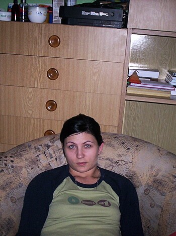 Image of hot brunette chick in gray t-shirt busting ass on the couch with her legs spread wide open, showing off her sexy pussy while talking to some dude on the phone.
