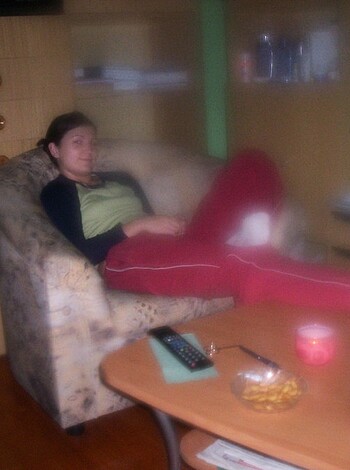 Vulgar description of image: A fuckin' person in their sexy red pants, kickin' it on the couch with some fuckin' white kicks, like a boss!