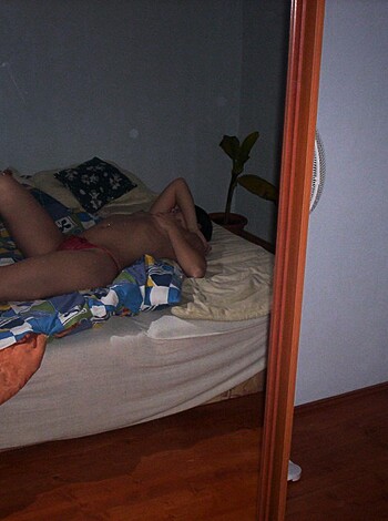 Vulgar Description:
Red bikini-clad babe lies on her back, exposing her pussy and ass to the camera as she lounges on a bed.