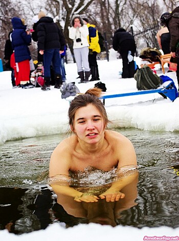 "Fucking hot chick shows off her tits in the snow while playing with dicks."