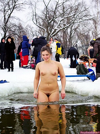 Here's a fuckin picture of a bitch standin in some piss-water with a buncha horny pricks surroundin her.