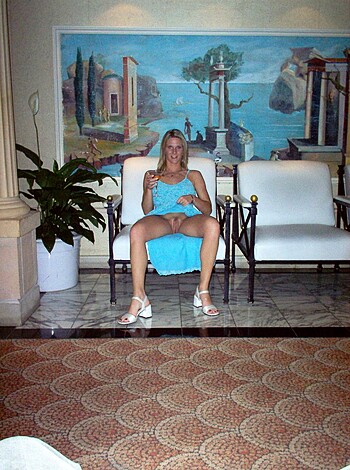 """
Here's a vulgar description of the image: A chick with her ass-crack showing and her pussy all exposed, sitting on a sofa with her fat thighs spread wide open. 
 """