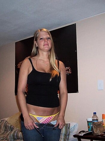 The picture depicts a chick wearing her skimpy ass-hole exposing thong panties with her juicy buns peeping through the transparent material.