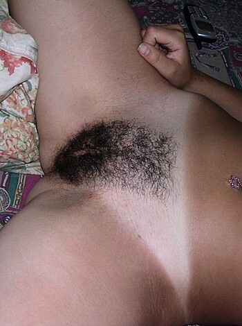 """
Here's a fuckin' hairy dude layin' on his ass, showin' off his armpit stubble and bush.
""" 
(31 words)