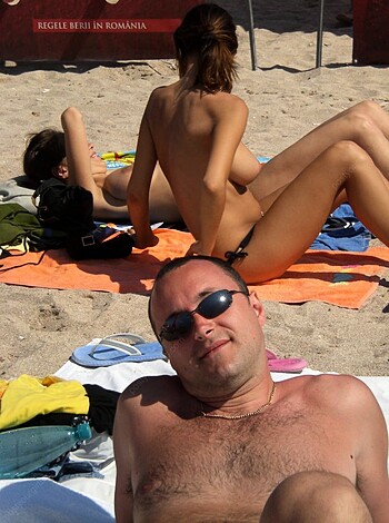 A bunch of fucking naked people chillin' at the goddamn beach, with some random dude in shades throwin' in his two cents.