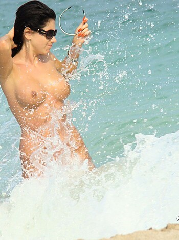"""
A fuckin’ nude bitch strokin’ her pussy on a beach while checkin’ her iPhone.
""" 

"""
A female figure with no clothes standing in the water, touching herself while using her mobile phone.
"""

"""
An unclothed female person placed in seawater, caressing her vagina while looking at a smartphone.
"""

"""
An individual of the female sex is in a bathing costume with no clothing, stroking herself while using her mobile device in the sea water.
"""