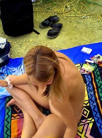 Vulgar description: Look at this fucking hot bitch, she's got a nice tight body and a sexy ass. She's lying on her blanket with her legs crossed, showing off those tits while smoking a goddamn cigarette like she owns the place. Man, I'd hit that shit in a fucking heartbeat if you know what I mean.