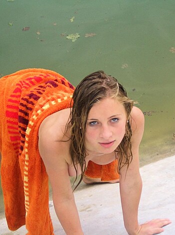 "Check out this chick's tight body bending over while drying off after a swim in the piss-colored pool with her ass and tits exposed."