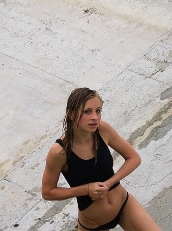 """
Bitch is on some fuckin' skyscraper shit, showing off her fake tits and ass in a goddamn bikini.
"""
