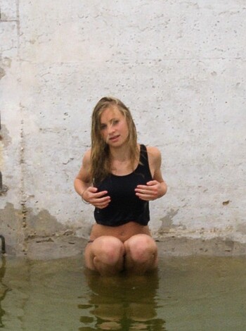 The bitch is down on her fucking knees, submerged in water up to her goddamn tits.