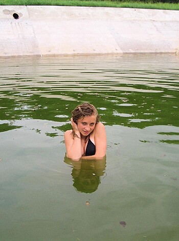 """ A chick taking a dip in a pool. """