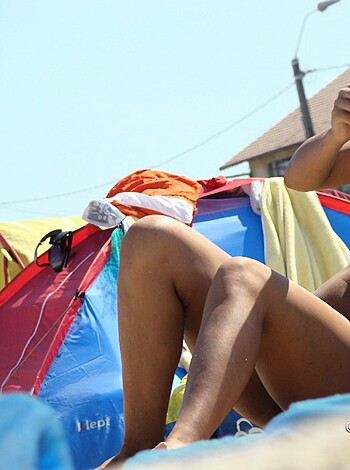 Look at this fucking picture of a dick-sucking bitch sipping Coca-Cola, while her fucking body is naked on the sandy beach.