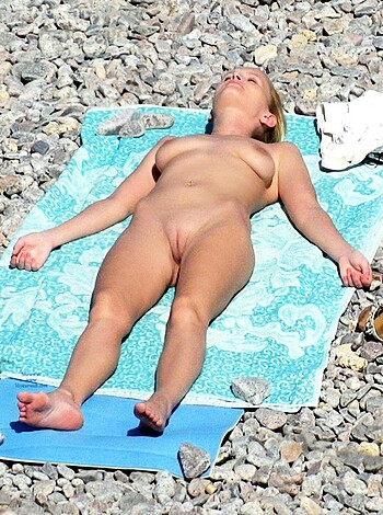 "This photo depicts a busty blonde chick lying naked on a fucking beach towel."