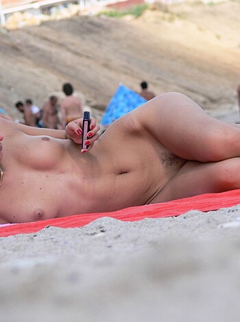 Nude babe lounging on the beach, fucking scrolling through her social media feed while holding her goddamn iPhone.
