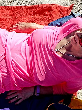 Vulgar description of image:
"Check out this f*ckin' hot chick loungin' on the sandy shore, lookin' all wet and sexy in her pink bikini that's clingin' to her tits and ass like a goddamn second skin. F*ck me running, this is one prime piece of tail."