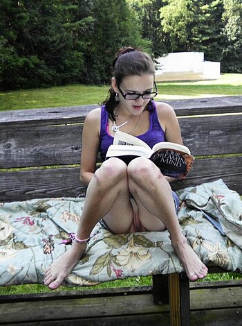 Virgin Mary fucking reads a book on her ass while lounging on a fluffy towel.