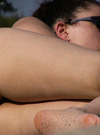 Fucking hot babe ass lying on fucking sandy beach with her tits and legs spread wide open for the camera to catch a glimpse of that tight pink pussy.