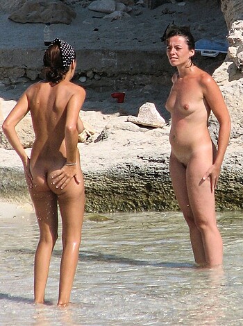 An attractive blonde in a bikini, wiping her ass on the sandy shore, leaving behind traces of shit that will eventually wash away with the tide.