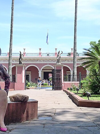 A naked broad with her ass up in the air, sitting on a park bench wearing some fuckin' pink stilettos.