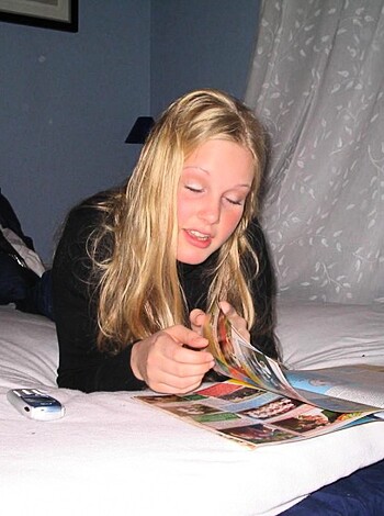 "Young whore fapping away on her saggy mattress, magazine propped up in her hand."