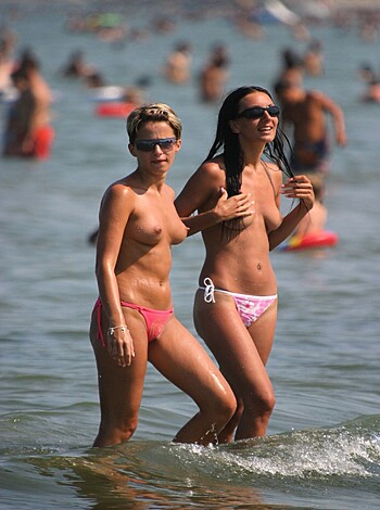 "Look at this fucking picture of two chicks on the fucking beach with a hot one in a teeny bikini top, and the other slutty cunt's bare tits out."