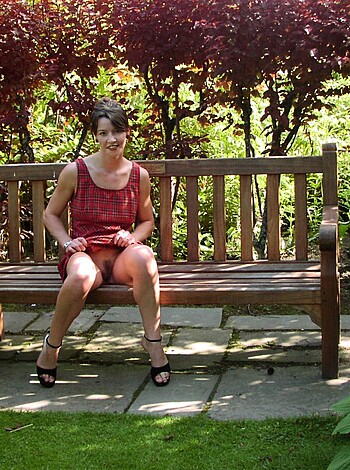 The chick is bumming on a park bench, dressed in her slutty best.