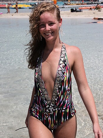 """
Cunt wearing two-piece bathing suit with boobies out for all to see at fucking beach!
"""