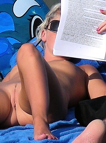 An erect cock with sandy ballsacks spreads out on the beach, while a chick lies ass-up on her fucking Kindle, eyes closed in blissful relaxation.