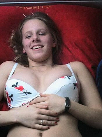 "Here's a fucking picture of some hot chick layin' down on a bed with a couple of red fuckin' pillows, wearin' only a tight bikini top and bottoms."
