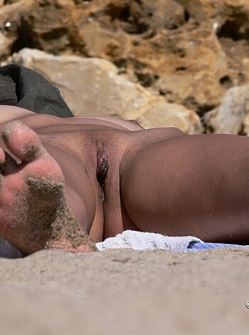 "Check out this dude with his dong hanging out on the sand."